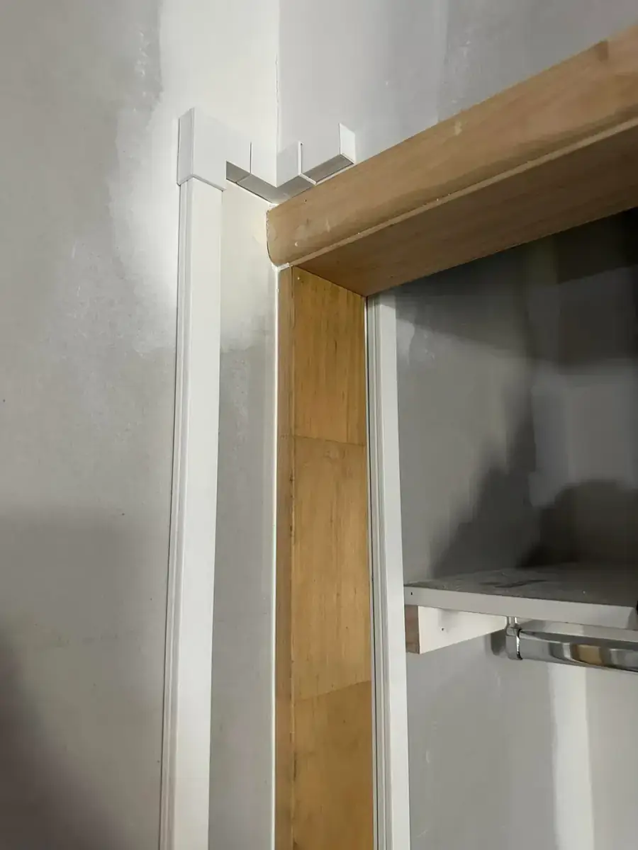 White conduit run beside a timber door frame during an electrical install by Electrikell Qld