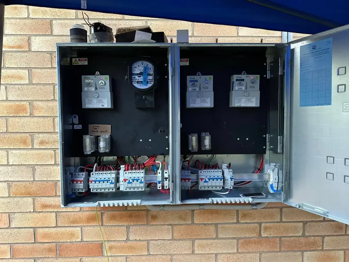 Multi-meter switchboard enclosure on a brick wall completed by Electrikell Qld in the Gladstone region